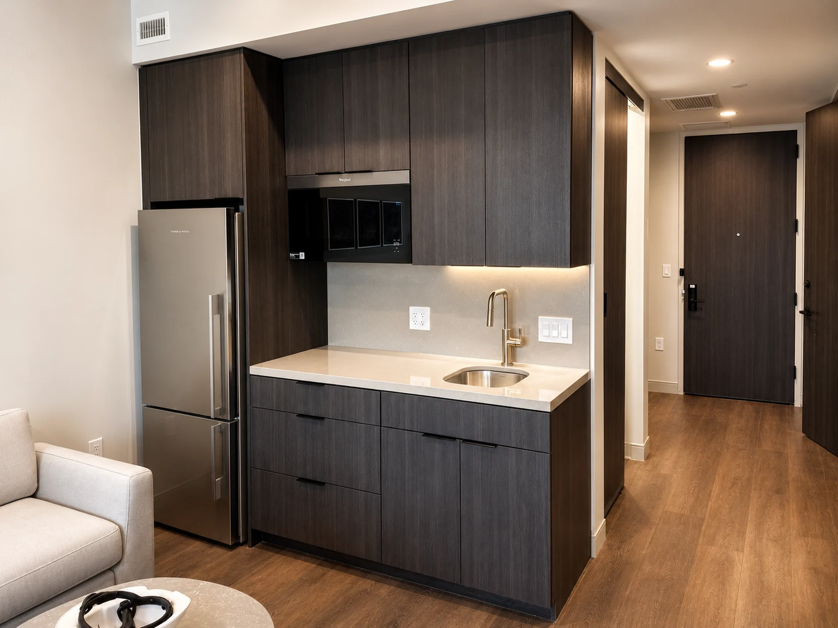 Dark wood cabinetry installed in a guestroom kitchenette